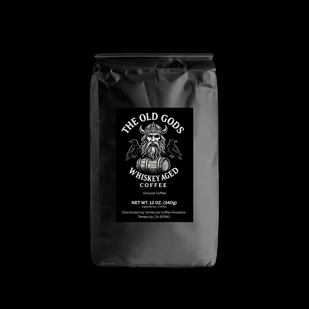 Whiskey Aged Coffee bag featuring The Old Gods branding and ground coffee details.